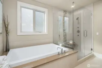 Relaxing soaking tub and walk-in shower with tile surround