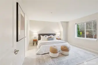 Large primary bedroom with ensuite bathroom, and walk in closet.