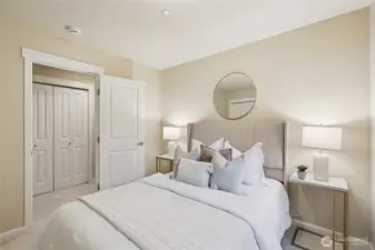 Bedroom with custom shelving in closet.