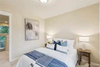 Bedroom with custom shelving in the walk in closet.