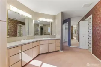 Primary bathroom looking towards toilet closet and clothes closet