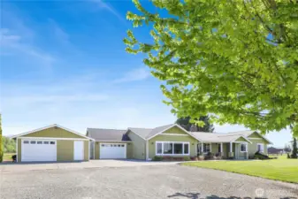 A fully updated 3-bedroom rambler with attached garage, detached garage, and 4-bay shop