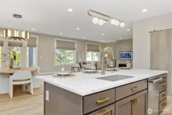 The ease of entertaining extends effortlessly from the kitchen to the adjacent dining and living rooms, creating a cohesive and welcoming space for gatherings of any size.