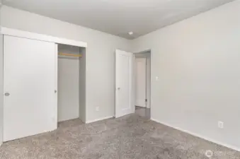 Another view of the guest bedroom, highlighting the sizable closet.