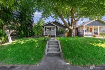 Enjoy great curb appeal with a welcoming walkway, mature front-yard tree & a cozy covered porch—perfect for relaxing.
