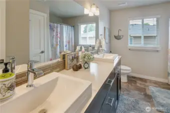 Tile flooring, Artisian designed Vessel sinks, new hardware makes this full bathroom stylish and functional.