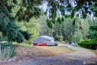 Don't miss the 3-stall shop with plenty of room for all of your toys.  The shop is across the driveway so the equipment is all out of sight.