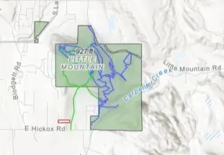 The property is shown in red.The trails are highlighted in green and blue.