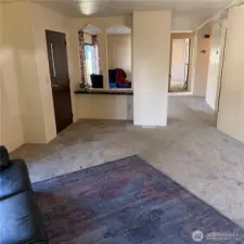 View of family room, front entry, and sitting area