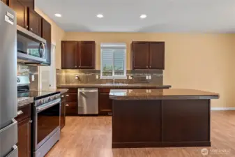 Granite tile counters with large island and eating bar