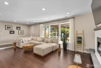 Sunken living room with a Burn Brite fireplace with masonry surround, strand-woven bamboo flooring, and recessed lighting