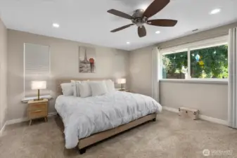 Bedroom number one with ceiling fan, craftsman trim, and 2-panel doors. Motion sensor lighting in the closet.