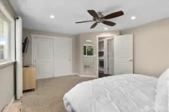 Bedroom number one with ceiling fan, craftsman trim, and 2-panel doors. Motion sensor lighting in the closet.