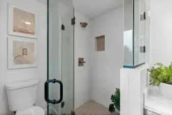 With floor-to-ceiling custom shower tiling, fit with it's own niche shower shelving, this en-suite showcases it's own vertical volume and spatial creativity.
