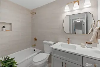 Shared between the second and third bedroom suite's, this newly designed custom tiled bathroom shares this home's theme blending luxury with functionality.