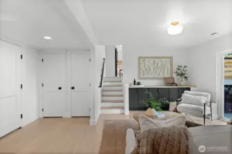 A masterfully zoned bottom level that maximizes the home’s footprint. This level integrates a high-capacity mudroom with a sophisticated secondary living area, offering a versatile environment from the garage or kitchen.