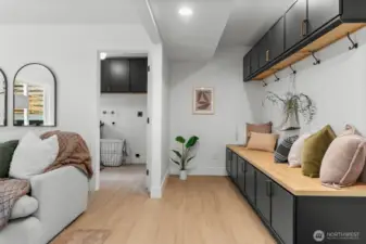 This high-utility mudroom serves as a strategic buffer between the garage and the main living quarters, ensuring organizational efficiency without compromising the home’s refined interior aesthetic.