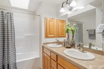 The second full bath features extra storage, dual sinks and a skylight.