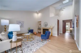 Step inside to a bright and inviting entryway, featuring soaring ceilings and a skylight that fills the space with natural light, even on the gloomiest days.