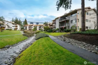 The beautifully maintained pathways throughout the community wind alongside a peaceful babbling brook.