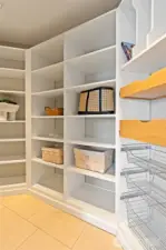 Spacious walk-in closet with built-ins.