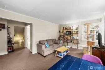 Living room looking to stairwell and kitchen