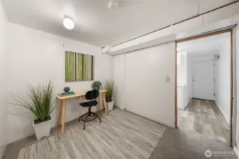 This lower-level room is staged as a home office but offers flexibility for a variety of uses, from a workout space to a guest room. Neutral finishes and a quiet setting make it a functional extension of the main living areas.