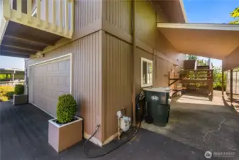 A covered area on the side of the home includes kayak storage racks.