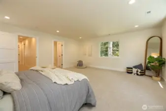 Massive primary bedroom with forest views.