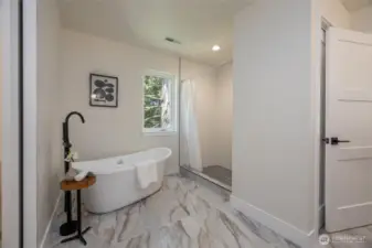 Primary bathroom with soaking tub and shower.