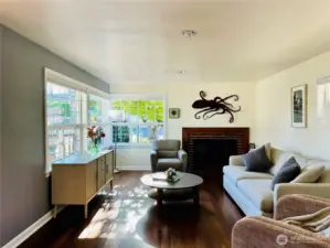 Afternoon sun shines softly though the large corner windows in the living room.