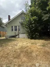 Set back off the street, with a beautifully restored home next door, this home could be next! SO much potential!