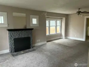 The living room opens directly to the dining area, the original windows are abundant in this space.