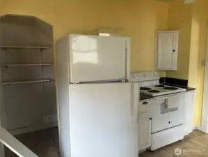 You can keep the vintage charm or there is plenty of space if you would like to make a completely updated kitchen that fits your needs. Whatever you choose there are options here! The nook to the left leads to a stairwell to the basement.