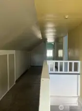 At the top of the stairs is a fully finished second floor with storage on the sides and a loft area that opens to the two upper bedrooms