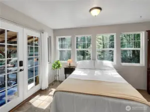 Sun-filled bedroom retreat with stunning windows & French doors.