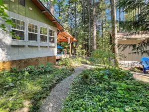Meander along the winding garden path in the peaceful backyard.