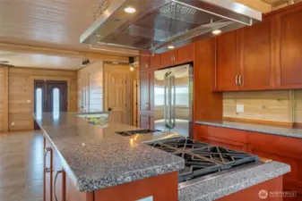 Gourmet Kitchen with High End Stainless appliances, gas range, radiant tile flooring & professional hood/vent.