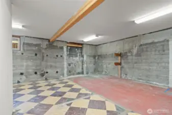 Part of the original home's flooring & foundation - this space off the garage has a lot of potential!
