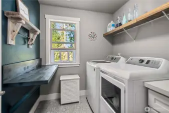 Upstairs laundry room with a window looking towards the greenbelt, you can hear birds singing, while doing the laundry!