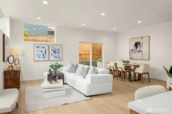 A wall of windows bathes this airy living space in natural light, inviting slow mornings, lively evenings, and everything in between.