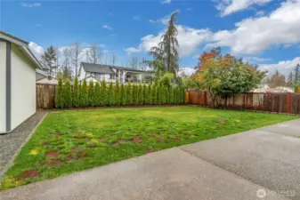 Fully fenced backyard with level lawn, large patio, and full irrigation system.