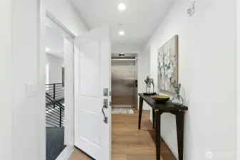Showing the hallway entrance & the elevator entrance directly into the home.