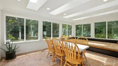 Light-filled sunroom with rows of skylights.