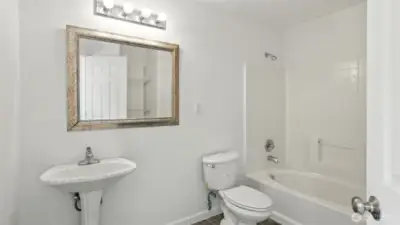 Full bath with tub/shower combo.