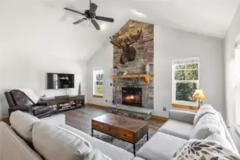 Open family room with stone surround fireplace