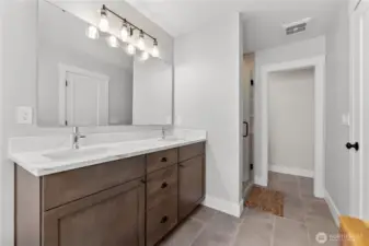 Double vanity and plenty of light in the en suite.
