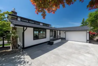 Show-stopping modern exterior with newly poured driveway and attached 2-car garage.