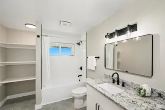Lower level full bath with built-in linen storage—offering style and everyday practicality in one clean, cohesive space.
