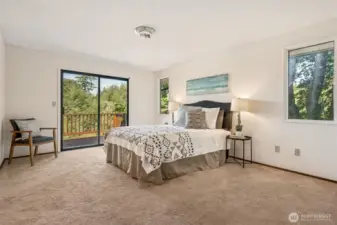 This primary suite gets all the best angles. Two vertical windows bring in filtered light, and the slider to the deck gives you an easy pass to the morning breeze and saltwater views. Latte-toned carpet adds warmth underfoot, while white walls keep the mood crisp and airy. It’s simple, serene, and exactly where you want to end the day.